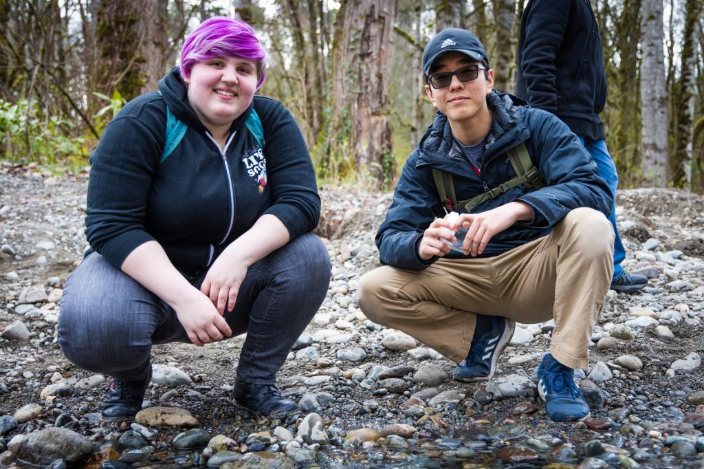 8/19 Two high school interns pose for a photo by the creek's edge.