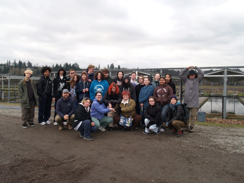 High school interns pose for a photo at a fish hatchery